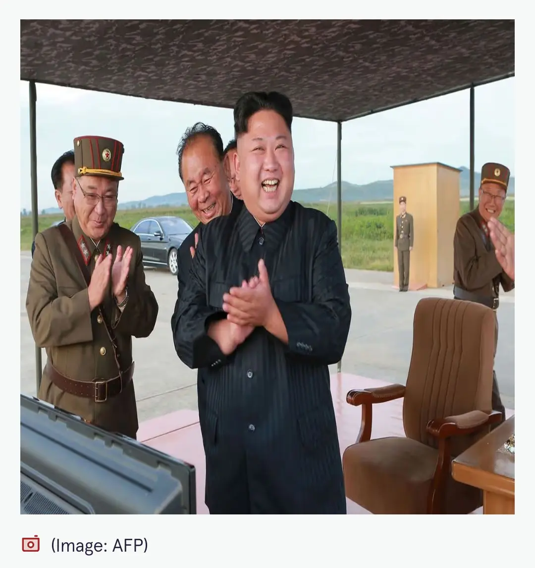 kim jong un & other north korean officials all laughing & clapping their hands