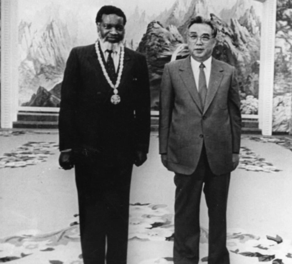 Sam Nujoma, first president of Namibia, receives a medal from Kim Il Sung 1986